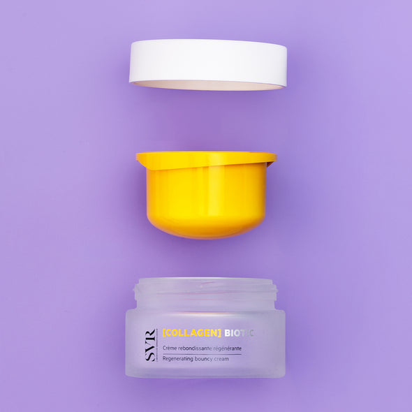 SVR Collagen Biotic cream jar with a yellow inner lid and white cap, displayed disassembled on a soft purple background.